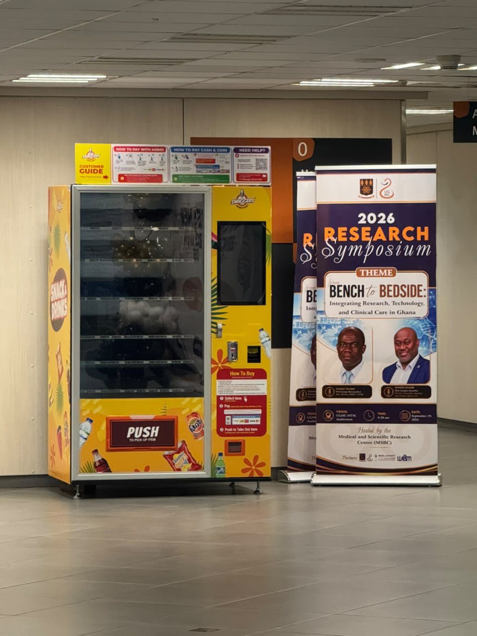 A Swaggers machine beside event banners at UGMC